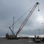 A crane is in the middle of an empty lot.