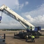 A crane is being used to lift a truck.